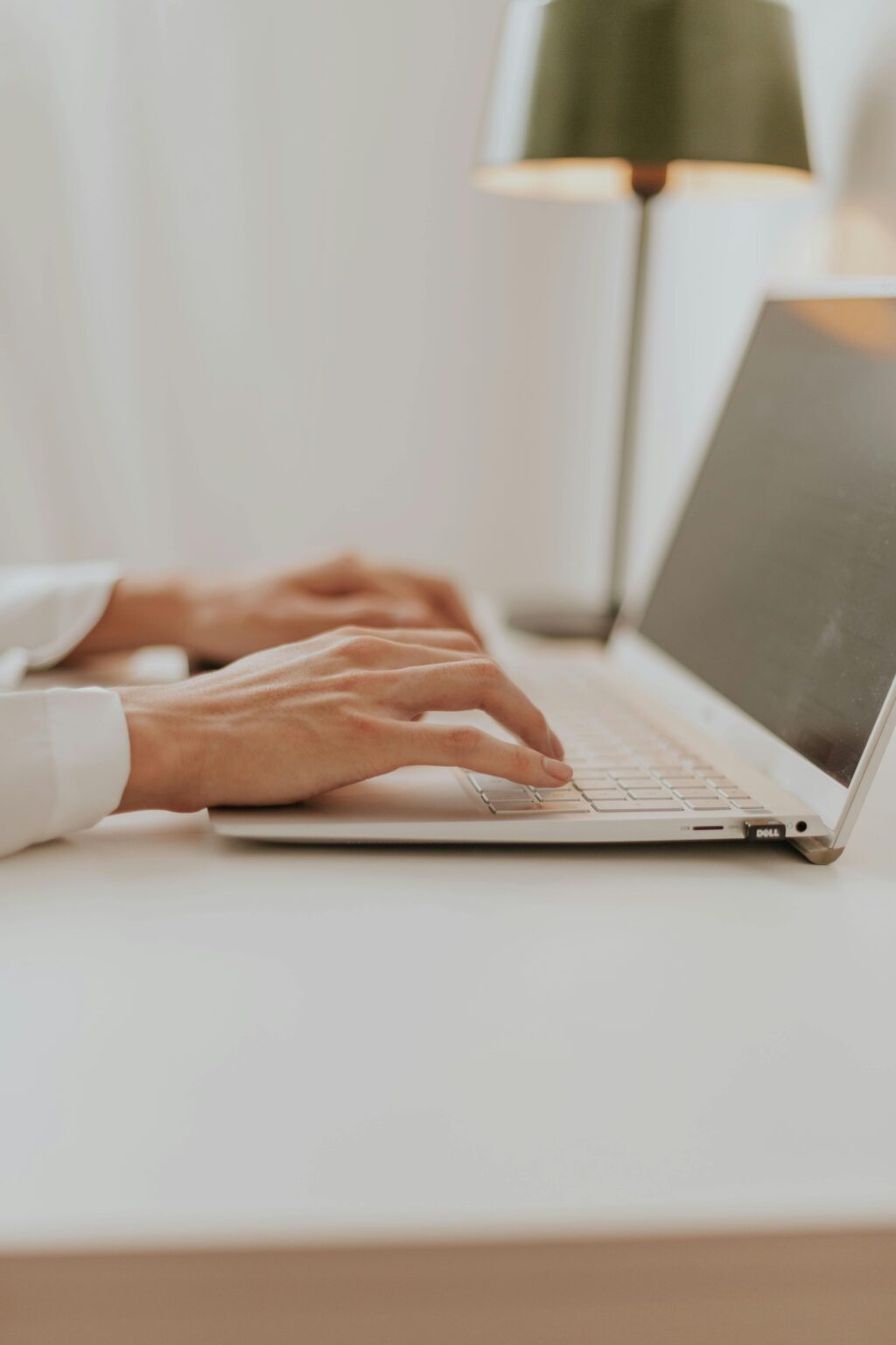 Hands Typing on Laptop