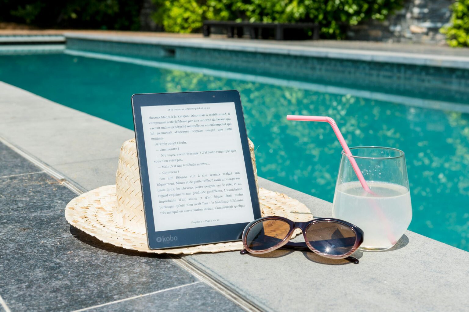 Black Kobo Table, Sunglasses, and a Glass of juice at Pool Edge