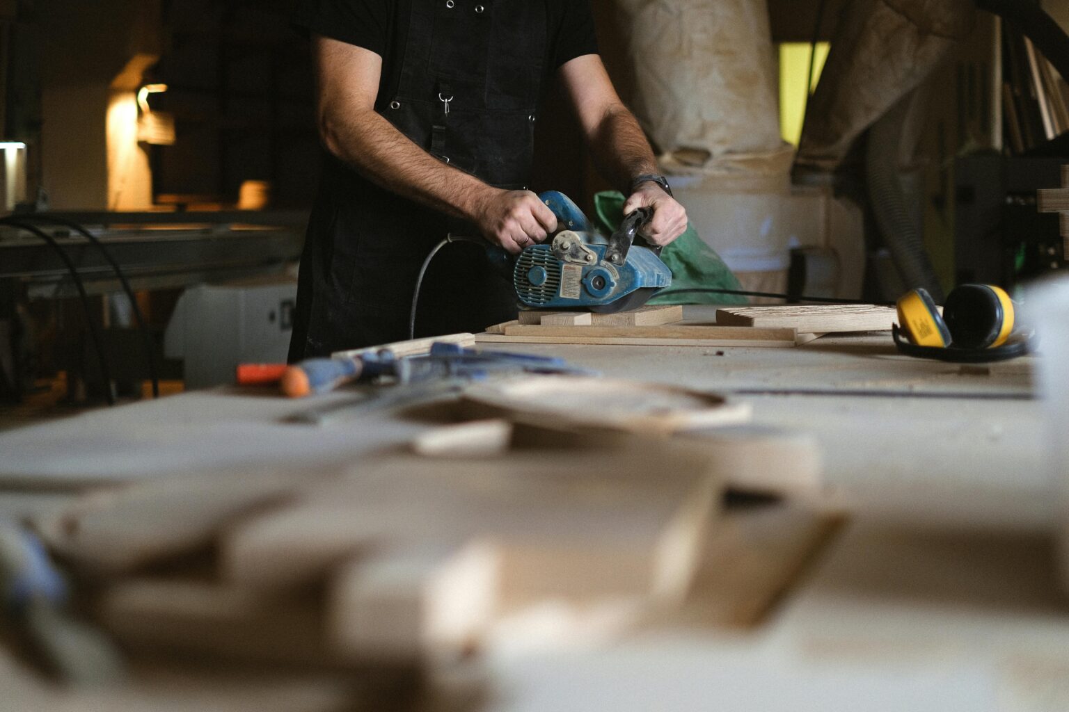 Crop carpenter polishing wooden board
